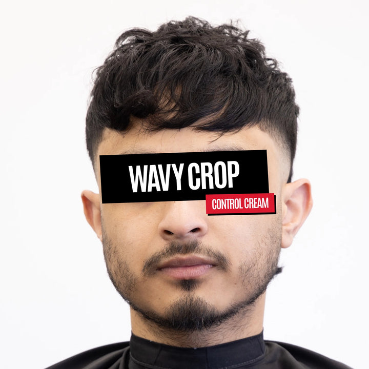 A man with a styled wavy crop haircut wearing a black neck cape, with a black censor bar over his eyes containing the text 'WAVY CROP' and a red label reading 'CONTROL CREAM'.