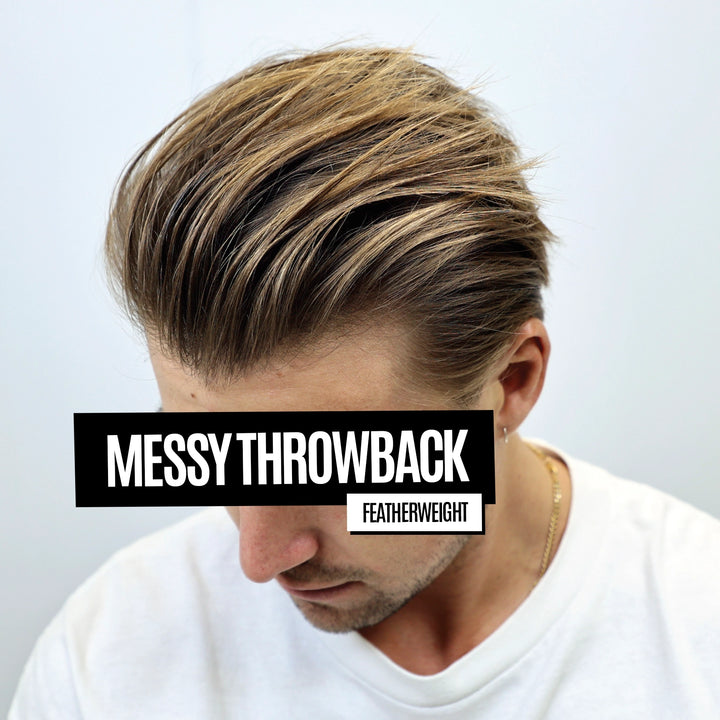 A man wearing a white crew-neck t-shirt, showcasing a styled messy throwback haircut with featherweight layers. A black text overlay reads 'MESSY THROWBACK' and 'FEATHERWEIGHT' is written in a smaller white box below it, set against a clean, light gray background.